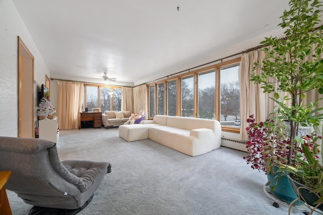 carpeted living room featuring ceiling fan and a baseboard radiator