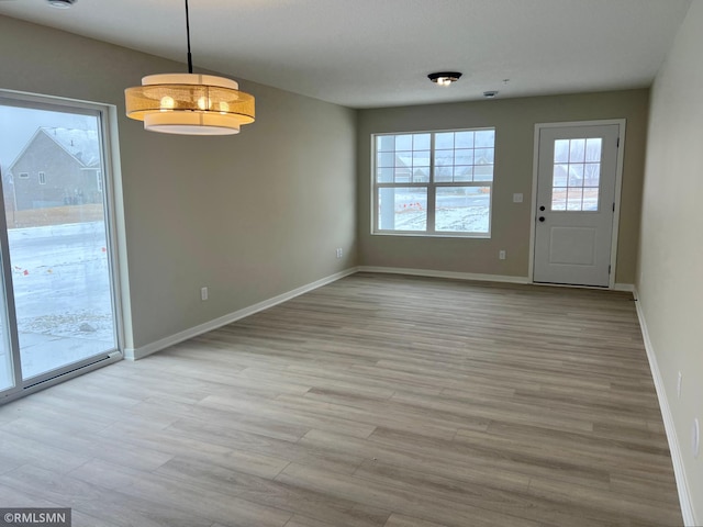 unfurnished dining area with light hardwood / wood-style floors