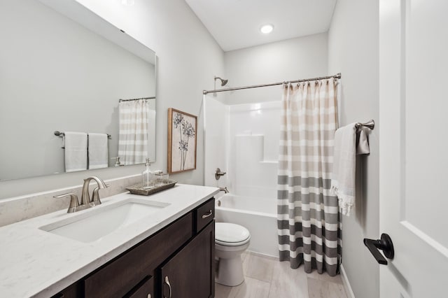 full bathroom featuring toilet, vanity, and shower / tub combo with curtain