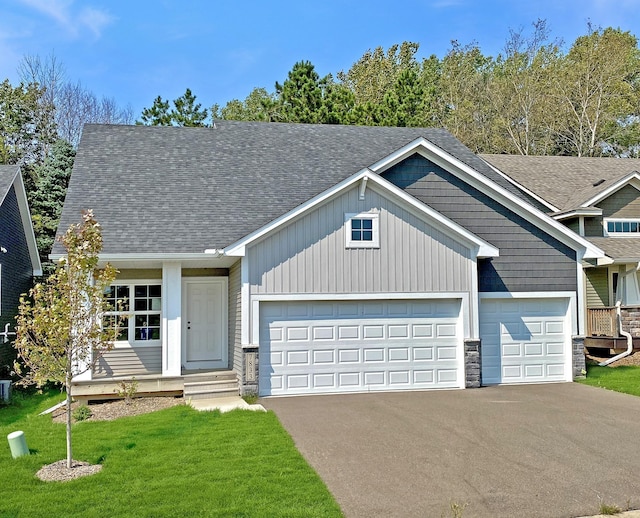 craftsman-style home with a front yard and a garage