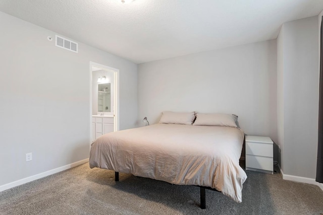 carpeted bedroom featuring connected bathroom