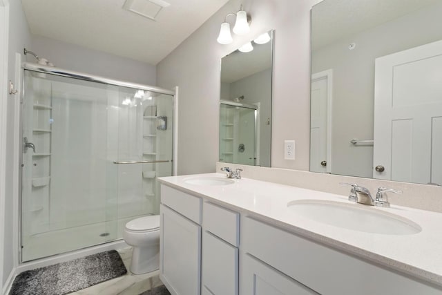 bathroom featuring vanity, toilet, and walk in shower