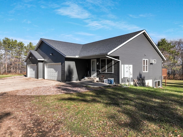 view of front of home with a garage and a front lawn