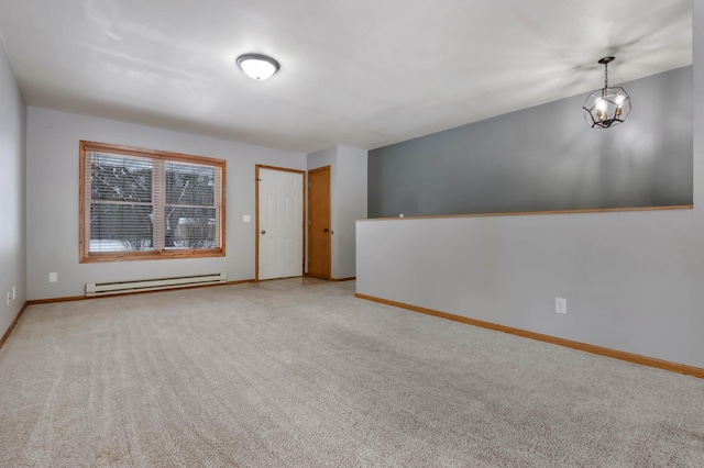 unfurnished room featuring a notable chandelier, carpet floors, and a baseboard heating unit