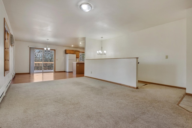 unfurnished living room featuring light carpet and a chandelier