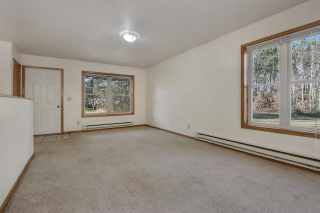 carpeted empty room with a healthy amount of sunlight and baseboard heating