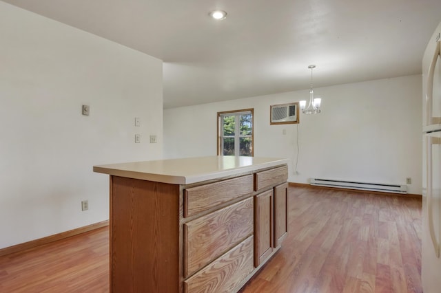 kitchen with a center island, hanging light fixtures, light hardwood / wood-style flooring, a baseboard radiator, and a wall unit AC