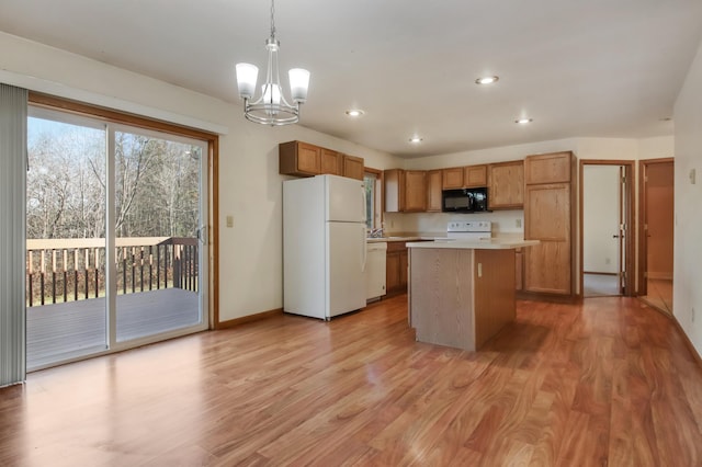 kitchen with a kitchen island, hanging light fixtures, white appliances, an inviting chandelier, and light hardwood / wood-style flooring