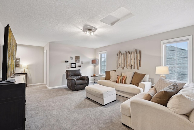 carpeted living room featuring a textured ceiling