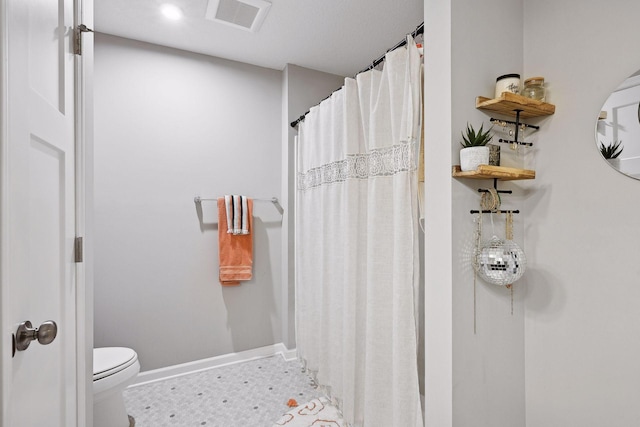 bathroom with curtained shower and toilet