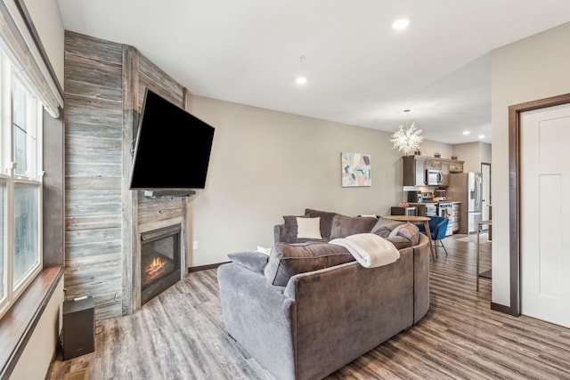 living room with a chandelier and light hardwood / wood-style floors