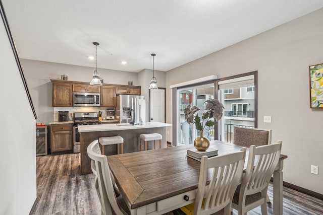 dining space featuring dark wood-type flooring and wine cooler