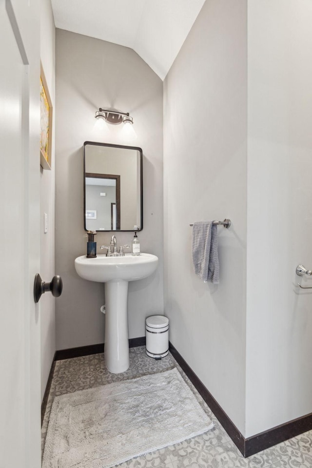 bathroom featuring lofted ceiling