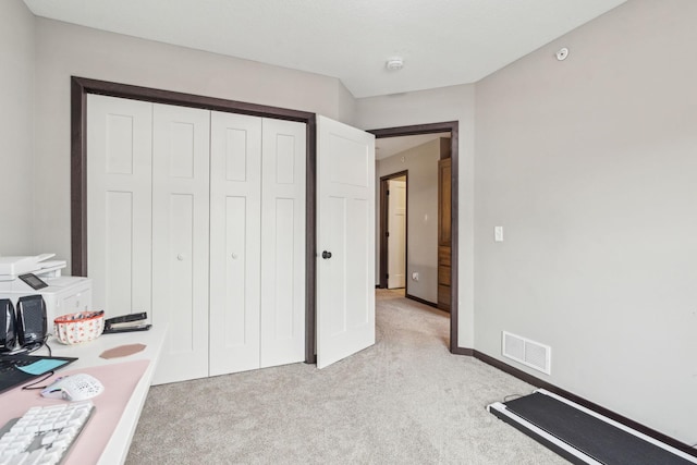 carpeted bedroom with a closet