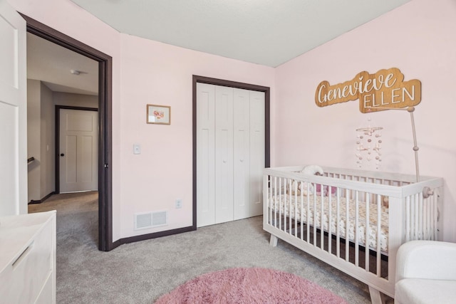 carpeted bedroom featuring a closet and a nursery area