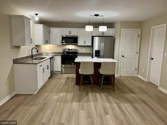 805 Tomahawk Ct, Madison Lake, MN 56063 - kitchen featuring a sink, a center island, appliances with stainless steel finishes, and light wood-style floors