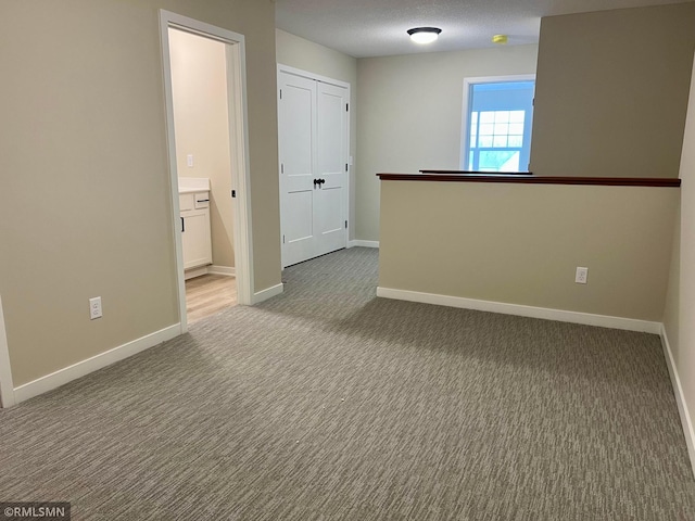 805 Tomahawk Ct, Madison Lake, MN 56063 - carpeted empty room with baseboards and a textured ceiling