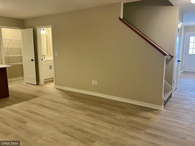 805 Tomahawk Ct, Madison Lake, MN 56063 - unfurnished living room featuring baseboards, light wood-style floors, and stairway