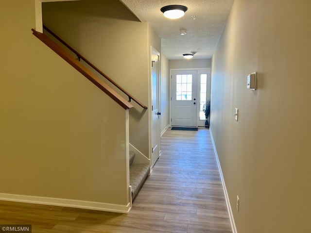 805 Tomahawk Ct, Madison Lake, MN 56063 - interior space featuring baseboards, stairs, a textured ceiling, and wood finished floors