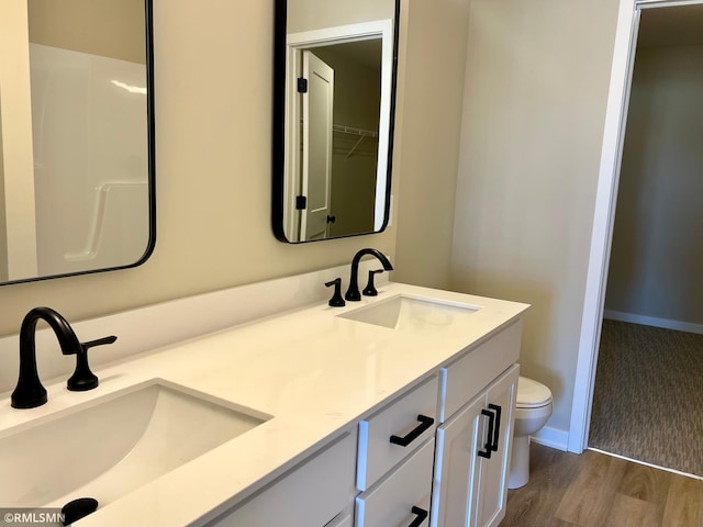 805 Tomahawk Ct, Madison Lake, MN 56063 - full bath featuring double vanity, a sink, toilet, and wood finished floors