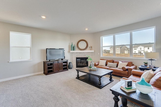 living room featuring a fireplace and carpet