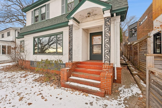 view of snow covered property entrance