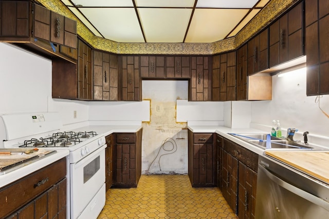 kitchen with dark brown cabinets, dishwasher, sink, and gas range gas stove