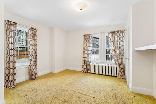 carpeted empty room with radiator