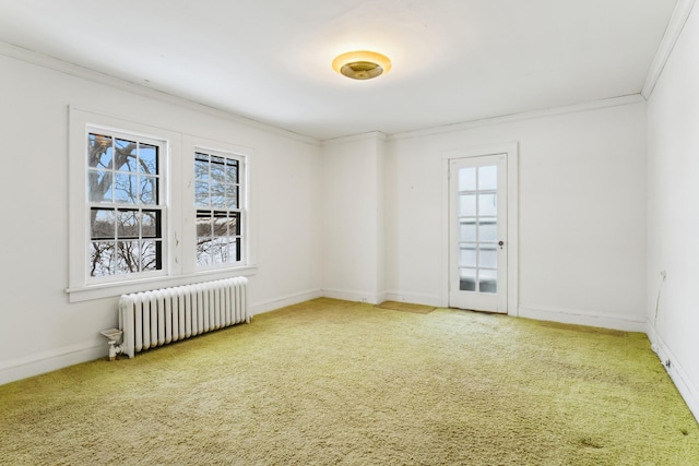 unfurnished room featuring ornamental molding, radiator, and carpet flooring