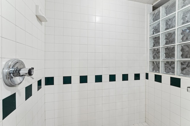 bathroom with a tile shower