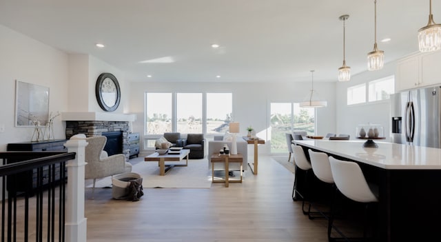 interior space featuring light wood-type flooring and a stone fireplace