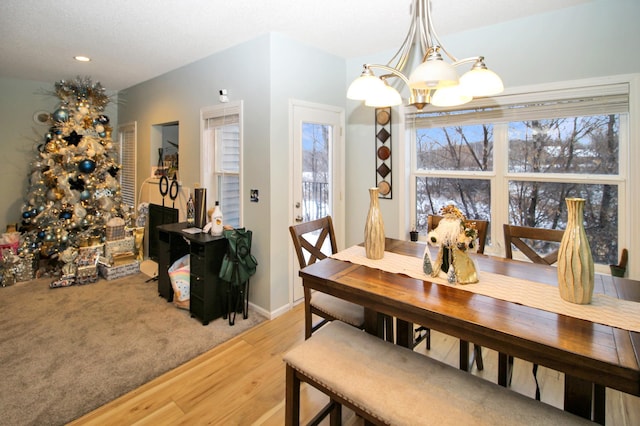 dining room featuring hardwood / wood-style flooring and a chandelier