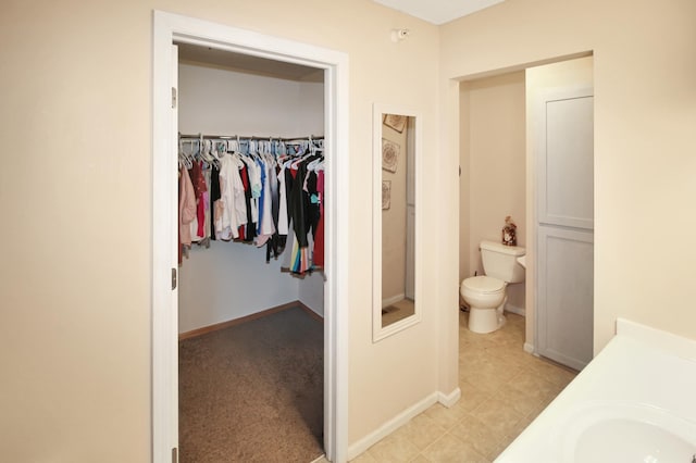 bathroom featuring tile patterned flooring, vanity, and toilet