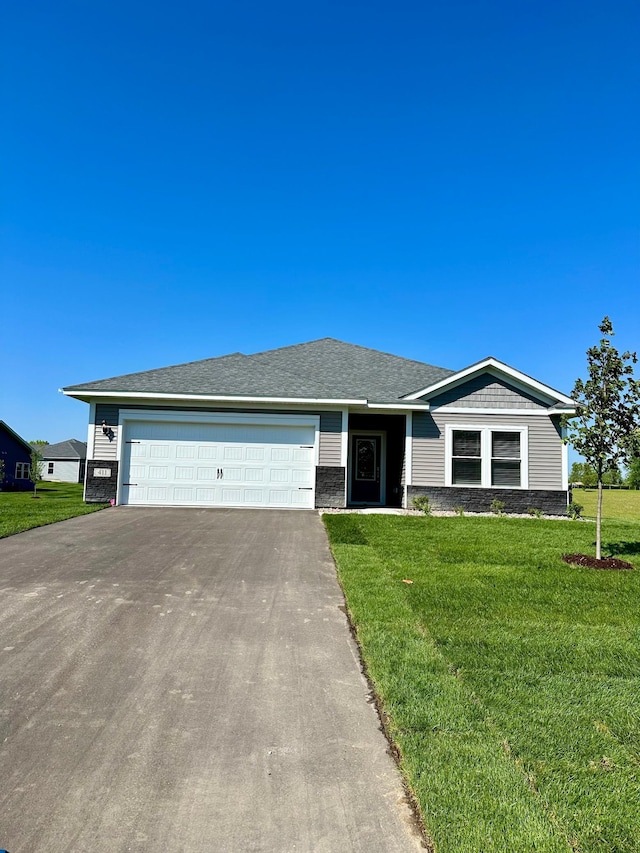 ranch-style house with a garage and a front lawn