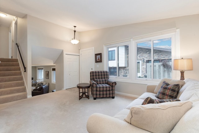 living room featuring light carpet and vaulted ceiling