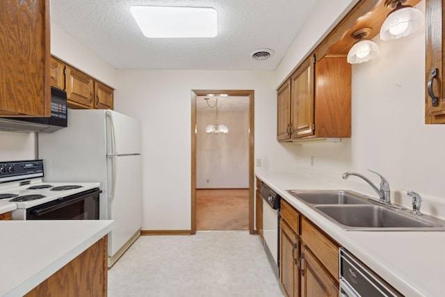 kitchen featuring pendant lighting, black appliances, sink, a textured ceiling, and a notable chandelier