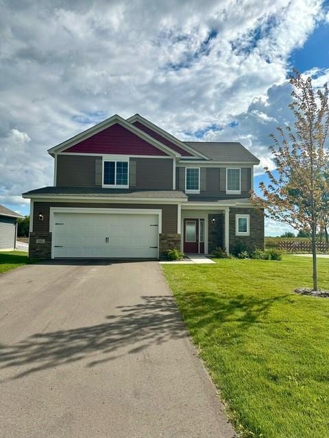 view of front facade featuring a front yard and a garage