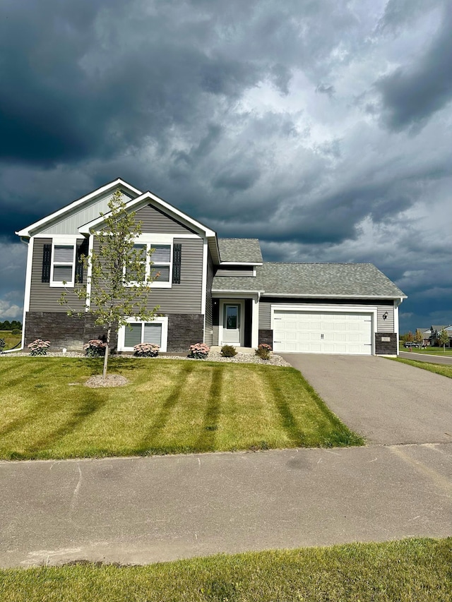 view of front of home with a garage and a front lawn