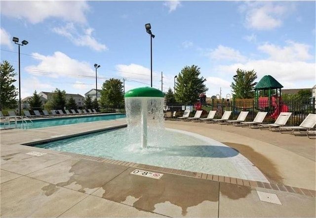 view of community with a patio area, a swimming pool, fence, and playground community