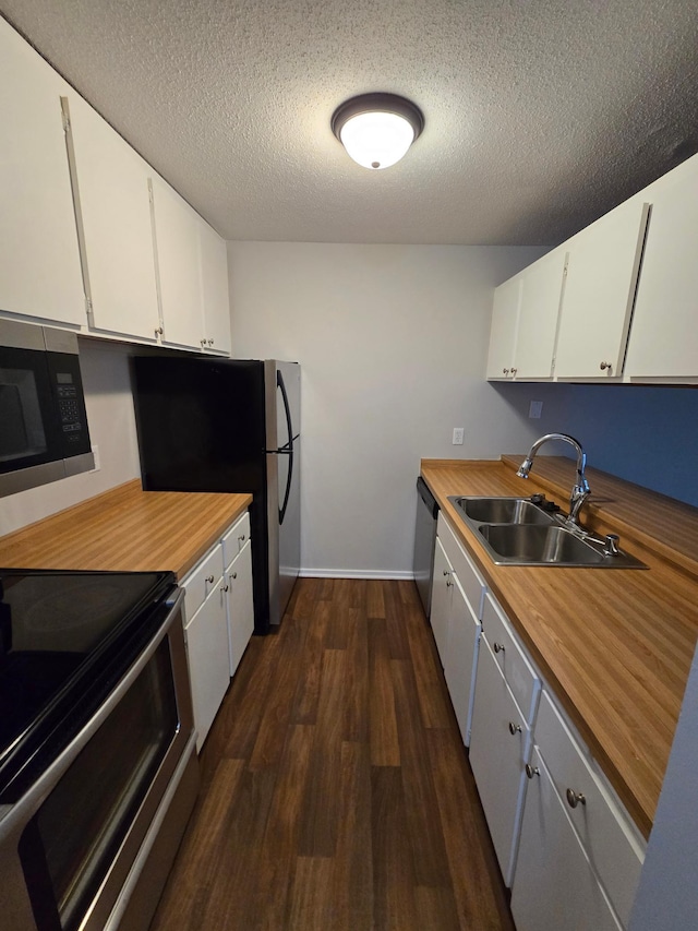 kitchen featuring white cabinetry, sink, dark hardwood / wood-style floors, a textured ceiling, and appliances with stainless steel finishes