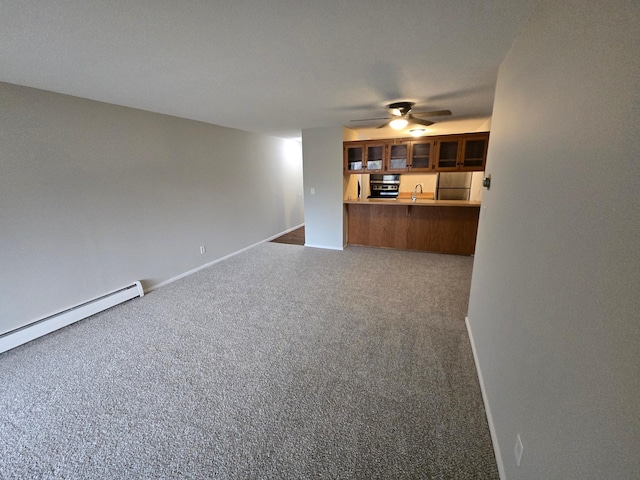 unfurnished living room with sink, carpet, and a baseboard radiator