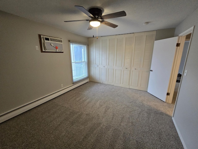 unfurnished bedroom with a textured ceiling, ceiling fan, a baseboard radiator, carpet floors, and a closet