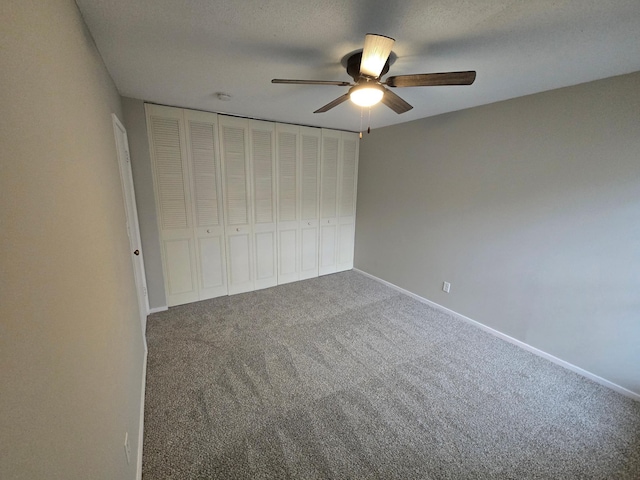 unfurnished bedroom featuring ceiling fan, a closet, carpet, and a textured ceiling