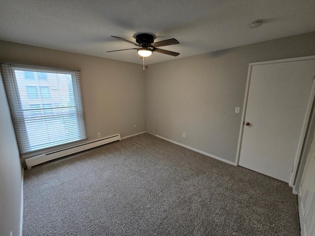 carpeted spare room featuring a textured ceiling, ceiling fan, and baseboard heating