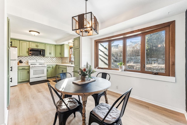 dining area with a healthy amount of sunlight and light hardwood / wood-style floors