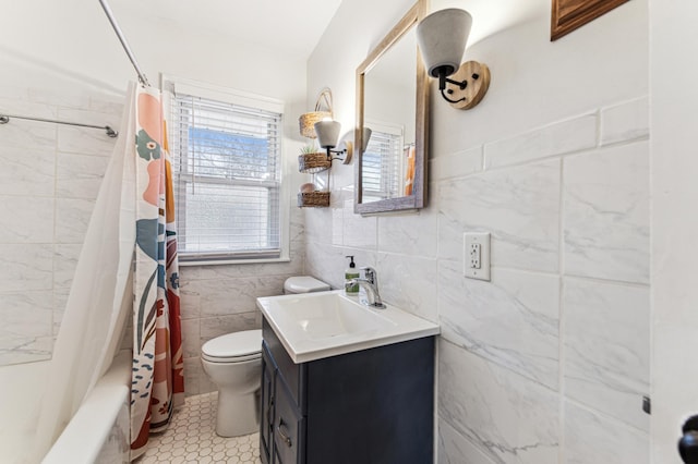 full bathroom with shower / tub combo, tile patterned floors, vanity, tile walls, and toilet