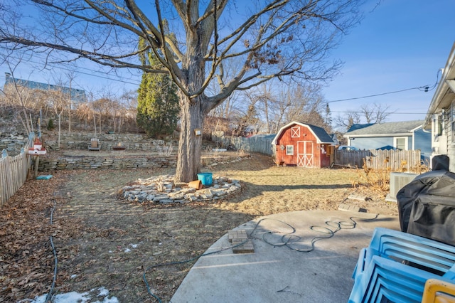 view of yard featuring a storage unit and a patio area