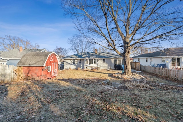 rear view of property featuring a shed