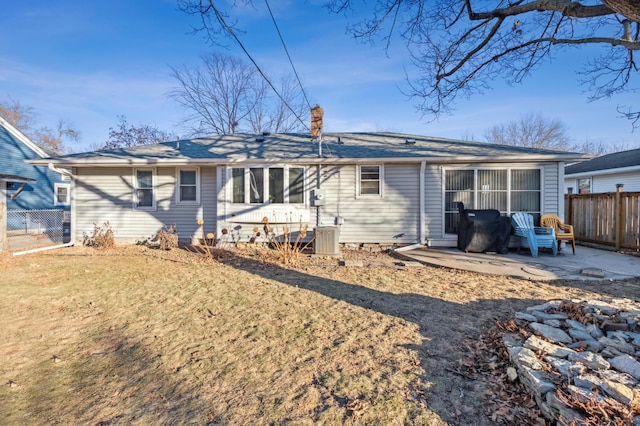 back of property featuring a patio area and a yard