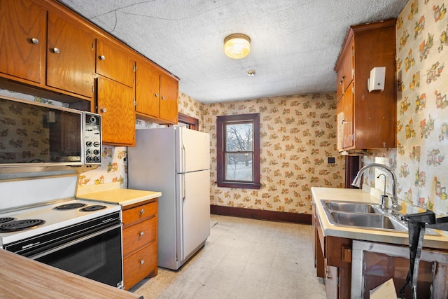 kitchen with sink and white appliances